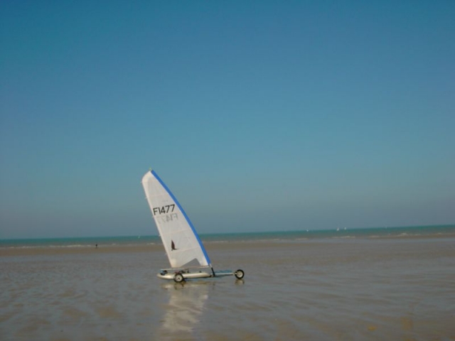  Sand yachting pushed by the wind 